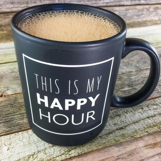 Black mug filled with coffee and printed with the words "This is my happy hour."